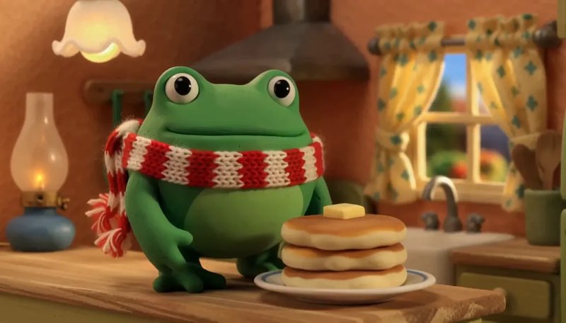 H3 Max stop-motion still: a claymation frog with pancakes in a tiny kitchen